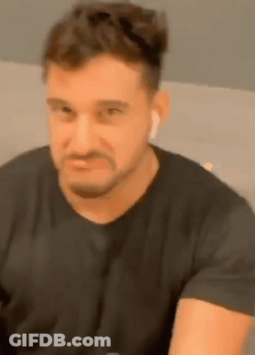 Bearded Man In Black Shirt And Ear Buds GIF