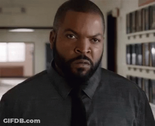Bearded Man In Black Shirt And Tie Looking At Camera GIF