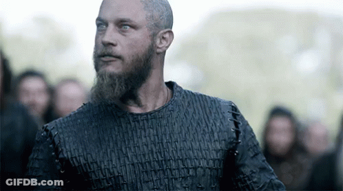 Bearded Man In Black Shirt Facing Crowd GIF
