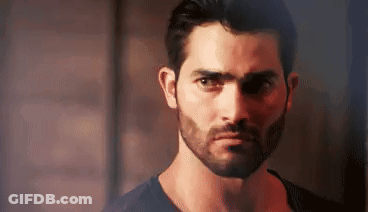 Bearded Man In Black Shirt Looking At Camera GIF