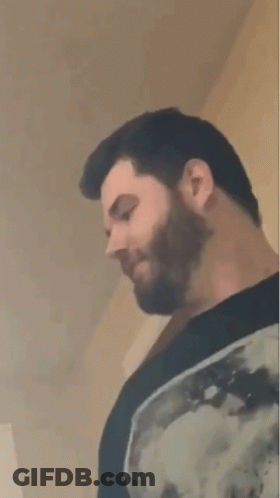 Bearded Man In Black Shirt Looking Down GIF