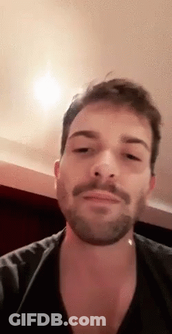 Bearded Man In Black Shirt With Mustache Looking GIF