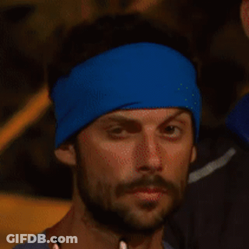 Bearded Man In Blue Headband Looks At Camera GIF