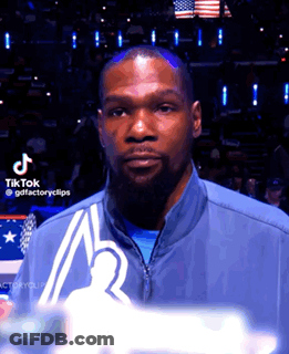 Bearded Man In Blue Jacket Before American Flag GIF