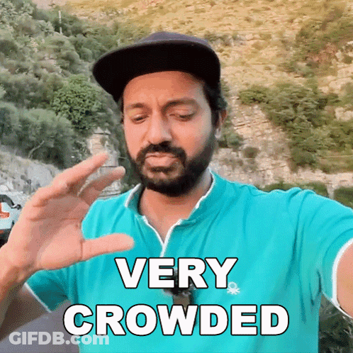 Bearded Man In Blue Shirt And Hat Saying Very Crowded GIF