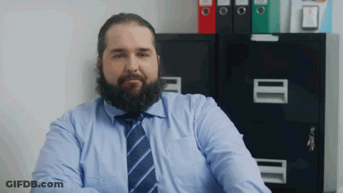 Bearded Man In Blue Shirt And Tie At Filing Cabinet GIF