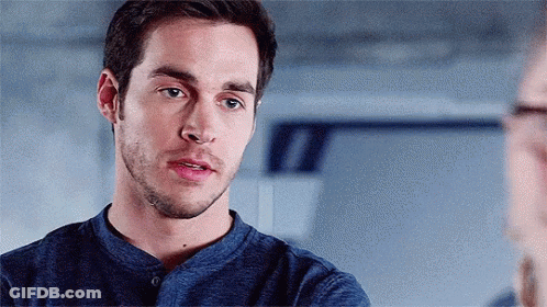 Bearded Man In Blue Shirt Looking At Another Man GIF