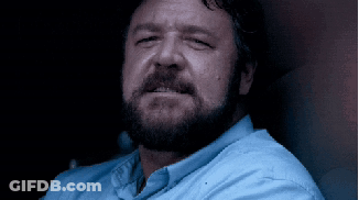 Bearded Man In Blue Shirt Looking At Camera GIF