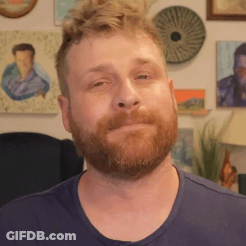 Bearded Man In Blue Shirt Looking At Camera GIF