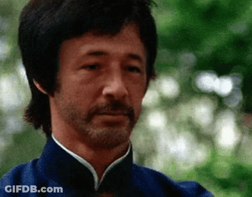 Bearded Man In Blue Shirt Looking At Camera GIF