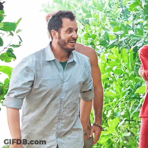 Bearded Man In Blue Shirt Smiling In Woods GIF