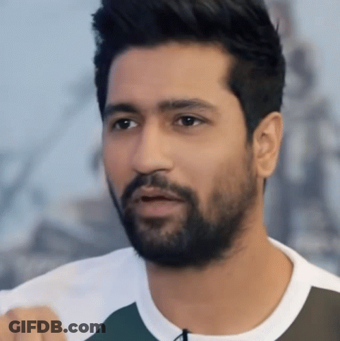 Bearded Man In Blue Sweater On Couch Hands Outstretched GIF