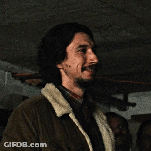 Bearded Man In Brown Jacket And Plaid Shirt Smiling GIF