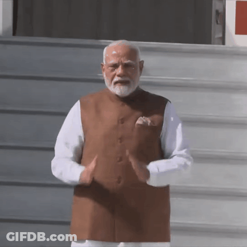 Bearded Man In Brown Vest And White Shirt GIF