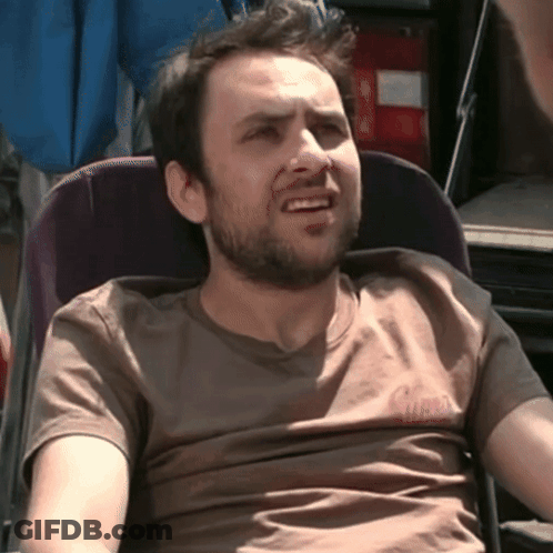 Bearded Man In Chair Wearing Guess T-Shirt GIF
