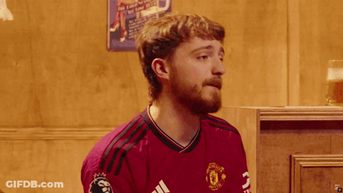 Bearded Man In Clown Wig And Maroon Shirt GIF