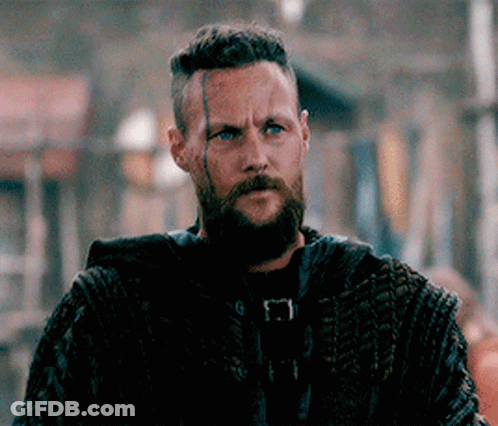 Bearded Man In Crowd Looking At Camera GIF