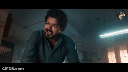 Bearded Man In Dark Room With Ceiling Light GIF