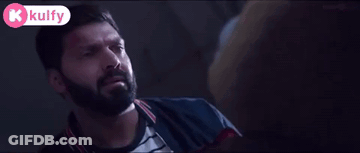 Bearded Man In Dark Room With Kolfy Logo GIF