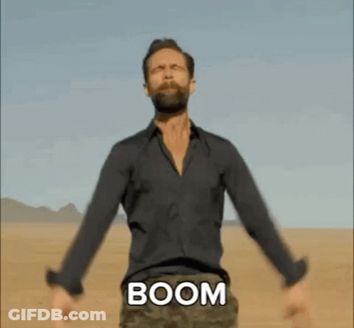 Bearded Man In Desert Arms Outstretched Chest Says Boom GIF