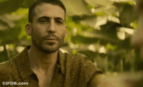Bearded Man In Floral Shirt Looking At Camera GIF