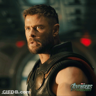 Bearded Man In Front Of Avengers Age Of Ultron Sign GIF