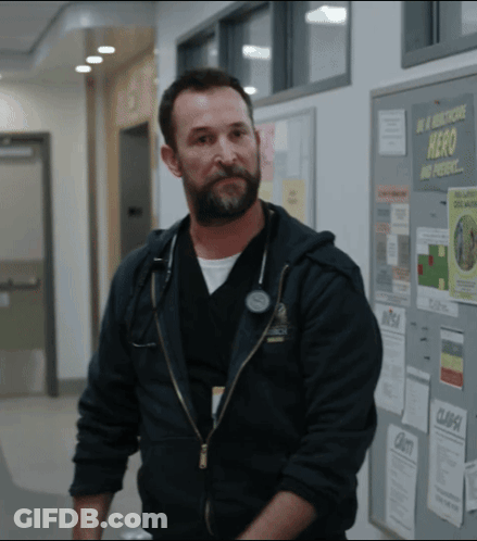 Bearded Man In Front Of Hero And Present Bulletin Board GIF