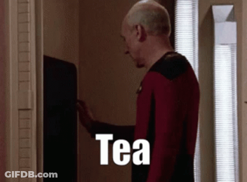 Bearded Man In Front Of Screen With Letter T GIF