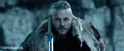 Bearded Man In Fur Coat Holding Sword GIF