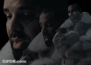 Bearded Man In Fur Coat Surrounded By Men GIF