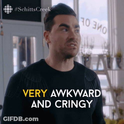 Bearded Man In Glasses And Suit Sitting On Couch GIF