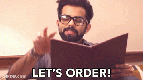Bearded Man In Glasses Reading Book Says Let's Order GIF