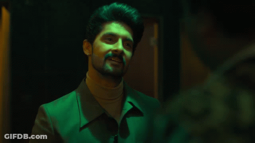 Bearded Man In Green Jacket And Turtleneck Smiling GIF