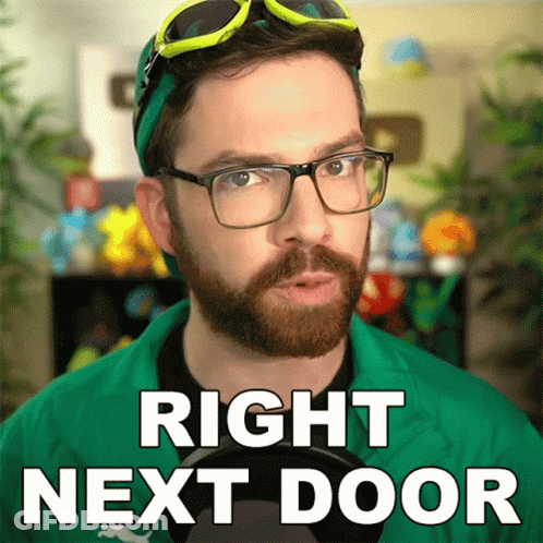 Bearded Man In Green Jacket Says Right Next Door GIF