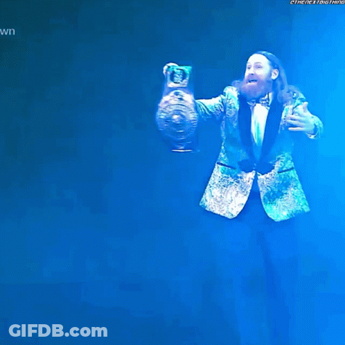 Bearded Man In Green Suit Holding Trophy GIF
