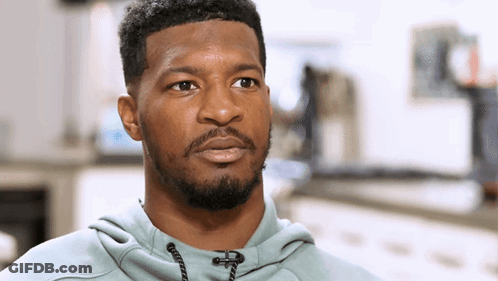 Bearded Man In Grey Hoodie Looking At Camera GIF