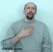 Bearded Man In Grey Sweater Making Heart Gesture GIF