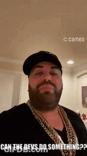 Bearded Man In Hat And Chains Saying Can The Devs Do Something GIF