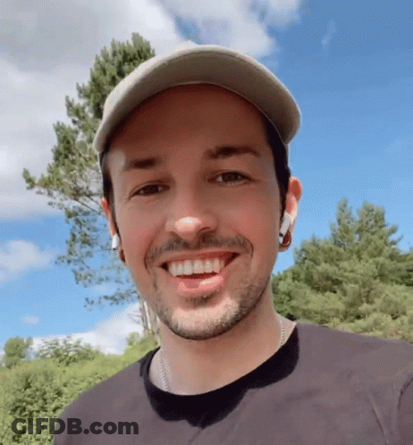 Bearded Man In Hat And Earbuds Smiling GIF