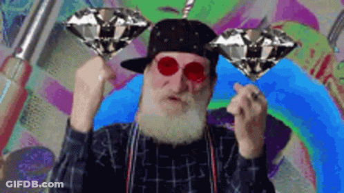 Bearded Man In Hat And Red Glasses Holding Two Diamonds GIF