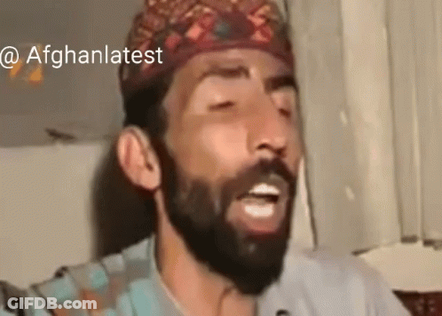 Bearded Man In Hat Singing Into Microphone GIF