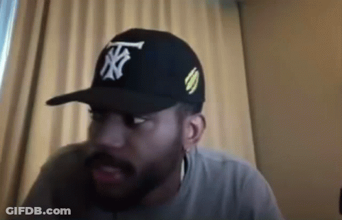 Bearded Man In Hat Sitting By Window GIF