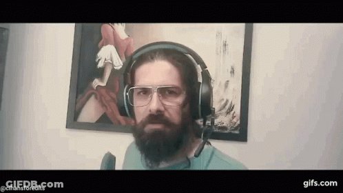 Bearded Man In Headphones And Glasses Before Painting GIF