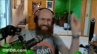 Bearded Man In Headphones Wearing Giant Shirt At Microphone GIF