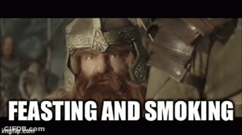 Bearded Man In Helmet And Armor With Feasting And Smoking GIF