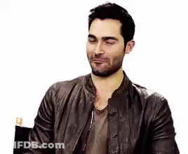 Bearded Man In Leather Jacket Sitting With Eyes Closed GIF