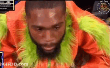 Bearded Man In Orange Green Fur Coat And Scarf GIF