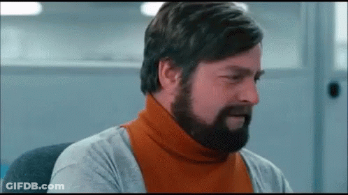 Bearded Man In Orange Turtleneck And Gray Shirt GIF