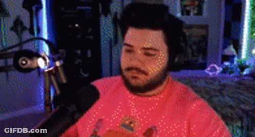 Bearded Man In Pink Shirt At Microphone GIF