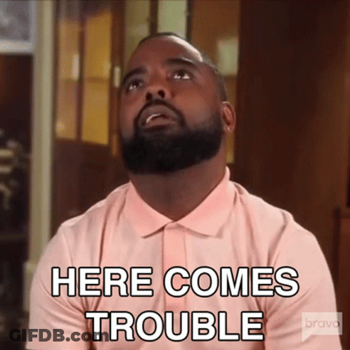 Bearded Man In Pink Shirt Says Here Comes Trouble GIF